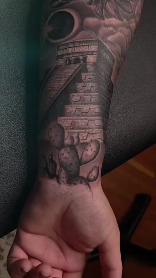 Kukulkan feathered serpent deity over Chichen Itza pyramid tattoo by Alex Zamora