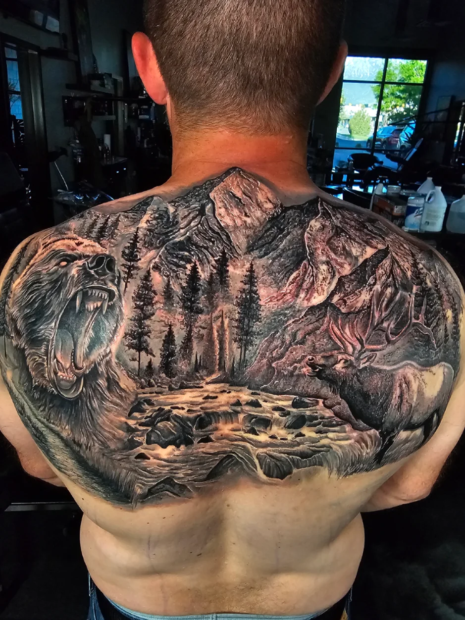 Bear and elk wilderness scene with mountains back tattoo by Alex Zamora